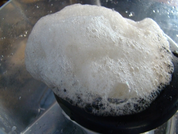 Close view of very stable foam flowing over into collection cup